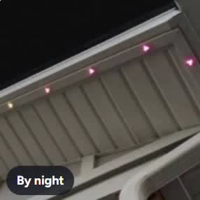 Bayline lights glowing along a soffit at night