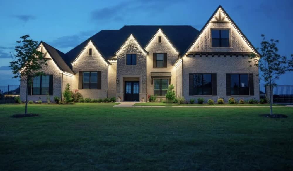 Home with warm white permanent lights along every roofline